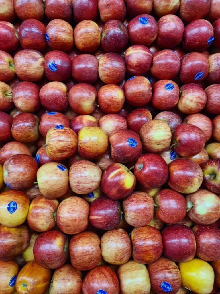 A vibrant and fresh display of ripe red apples in a grocery store setting.