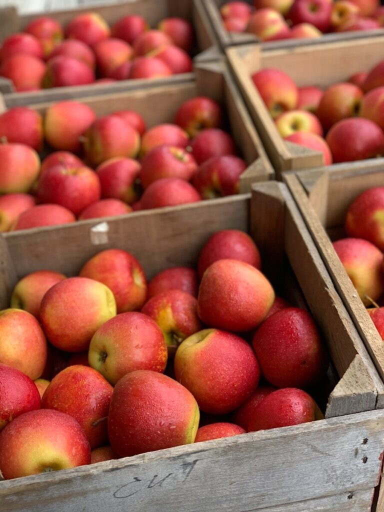 red apples on brown wooden crate